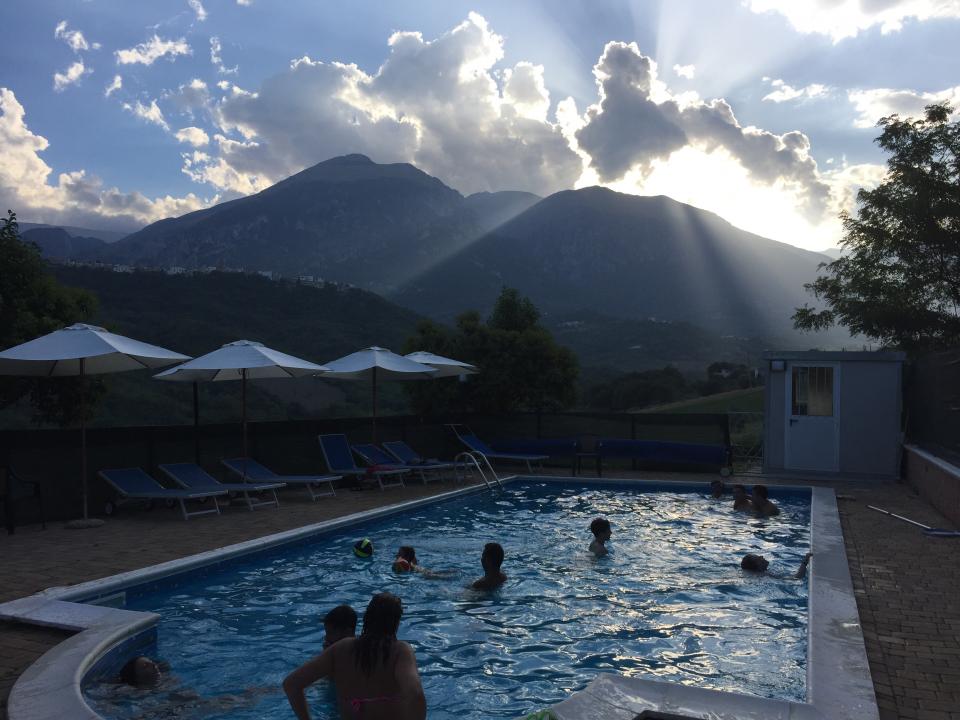 Sunset shot of small pool with parasols